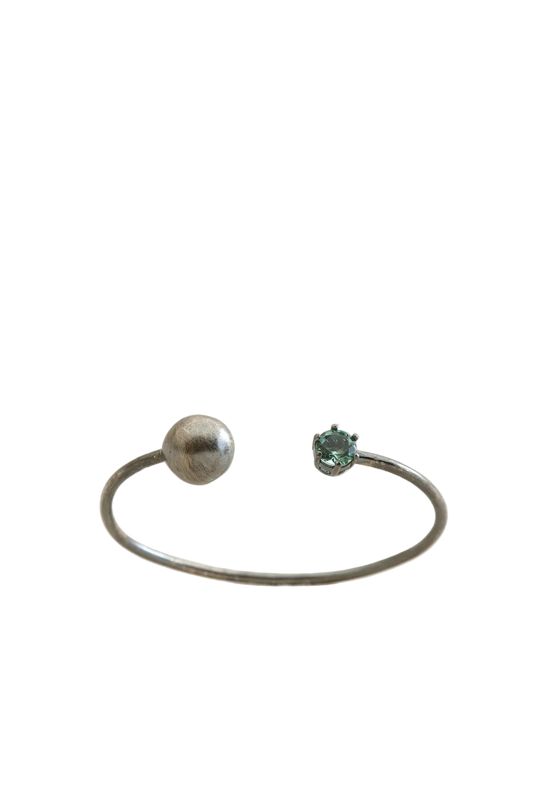 Two bracelets with gemstones on a light beige background