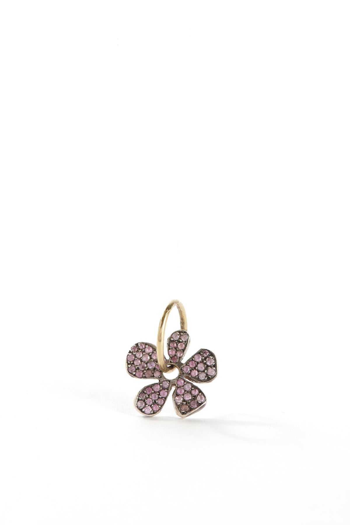 Flower-shaped earring with pink gemstones on a white background