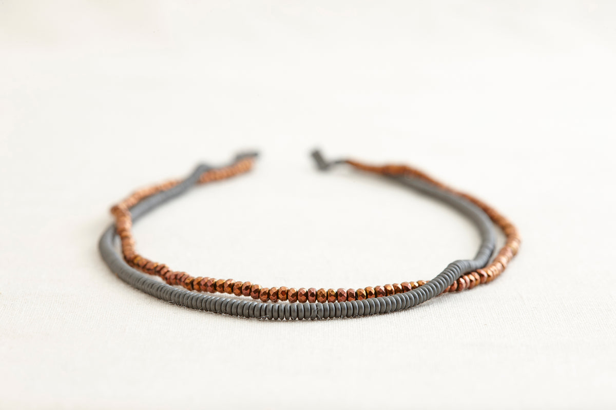 Necklace with gray and brown beads on a white background