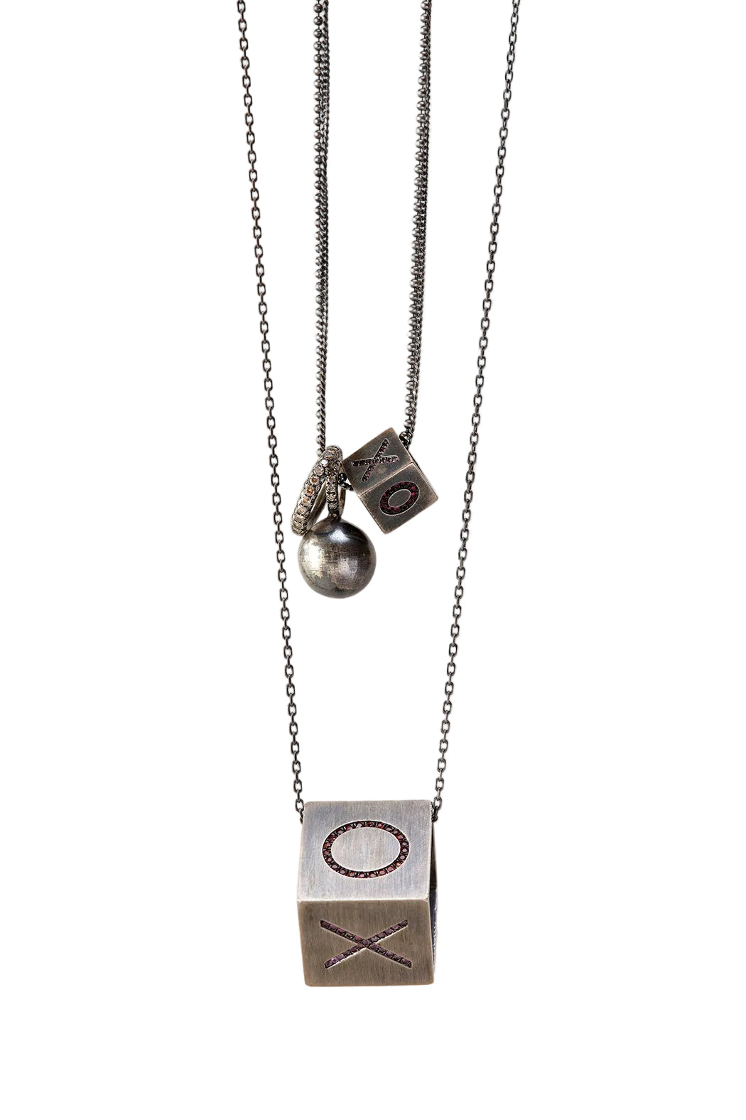 Necklace with a cube pendant and chain on a light gray background