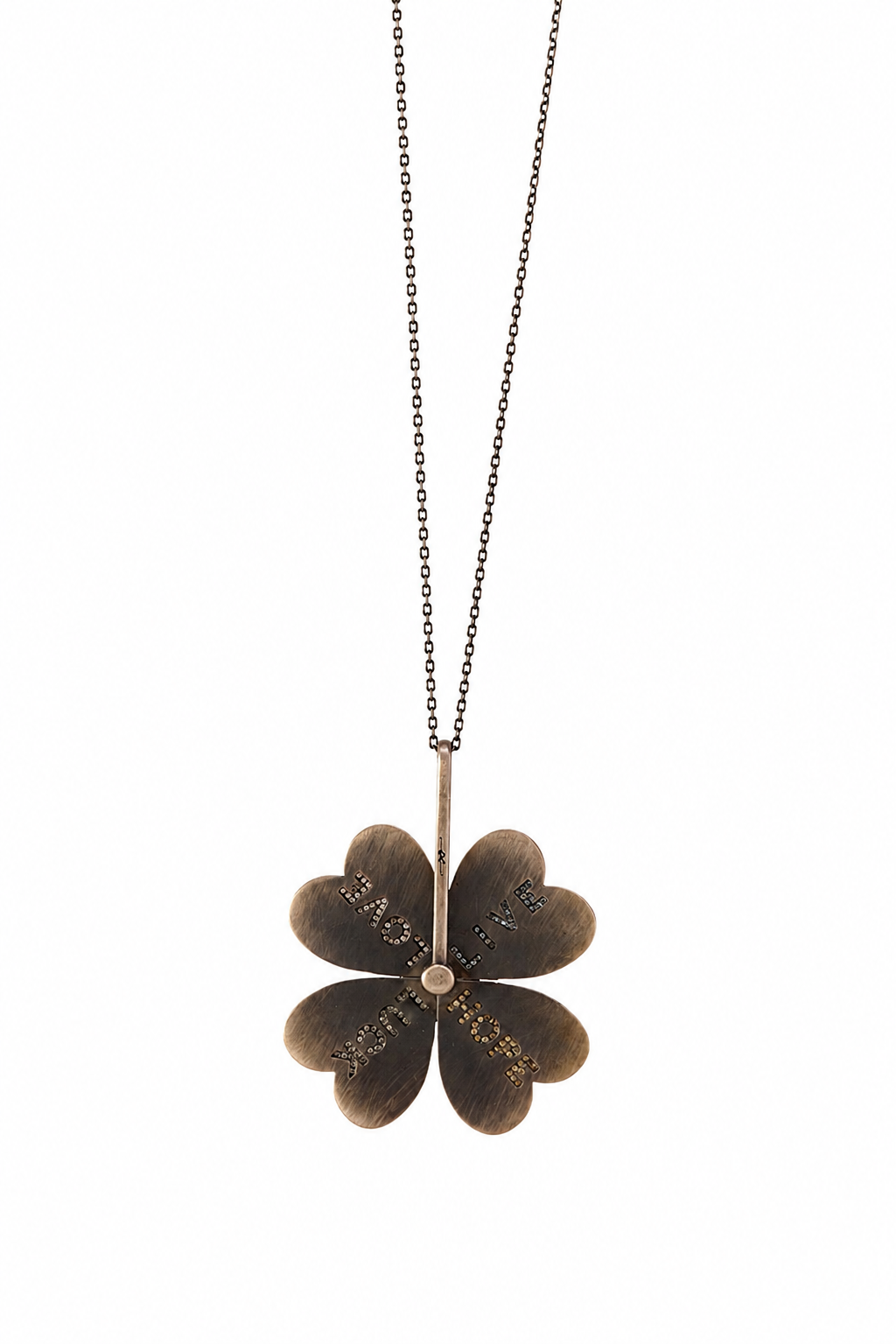 A dark bronze four-petal flower pendant necklace with engraved script details, suspended from a delicate dark metal chain against a solid white background.