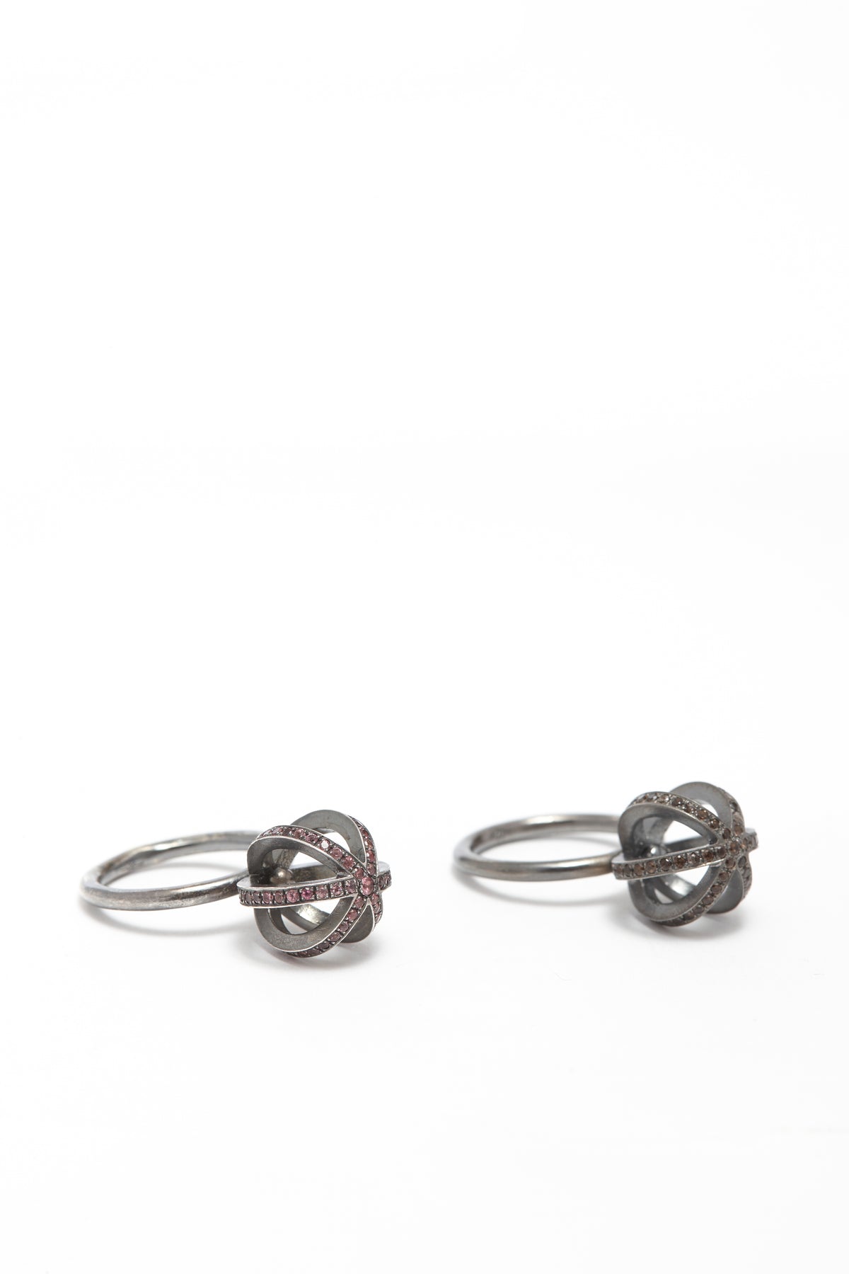 Pair of silver knot-shaped earrings on a white background