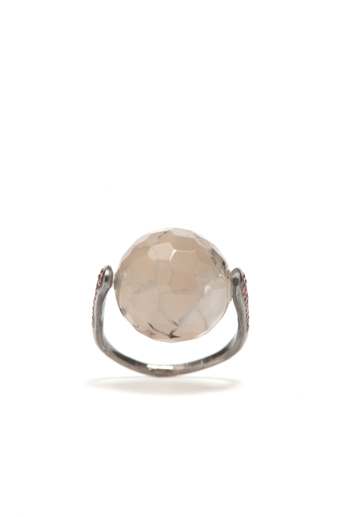 Ring with a large round stone on a white background