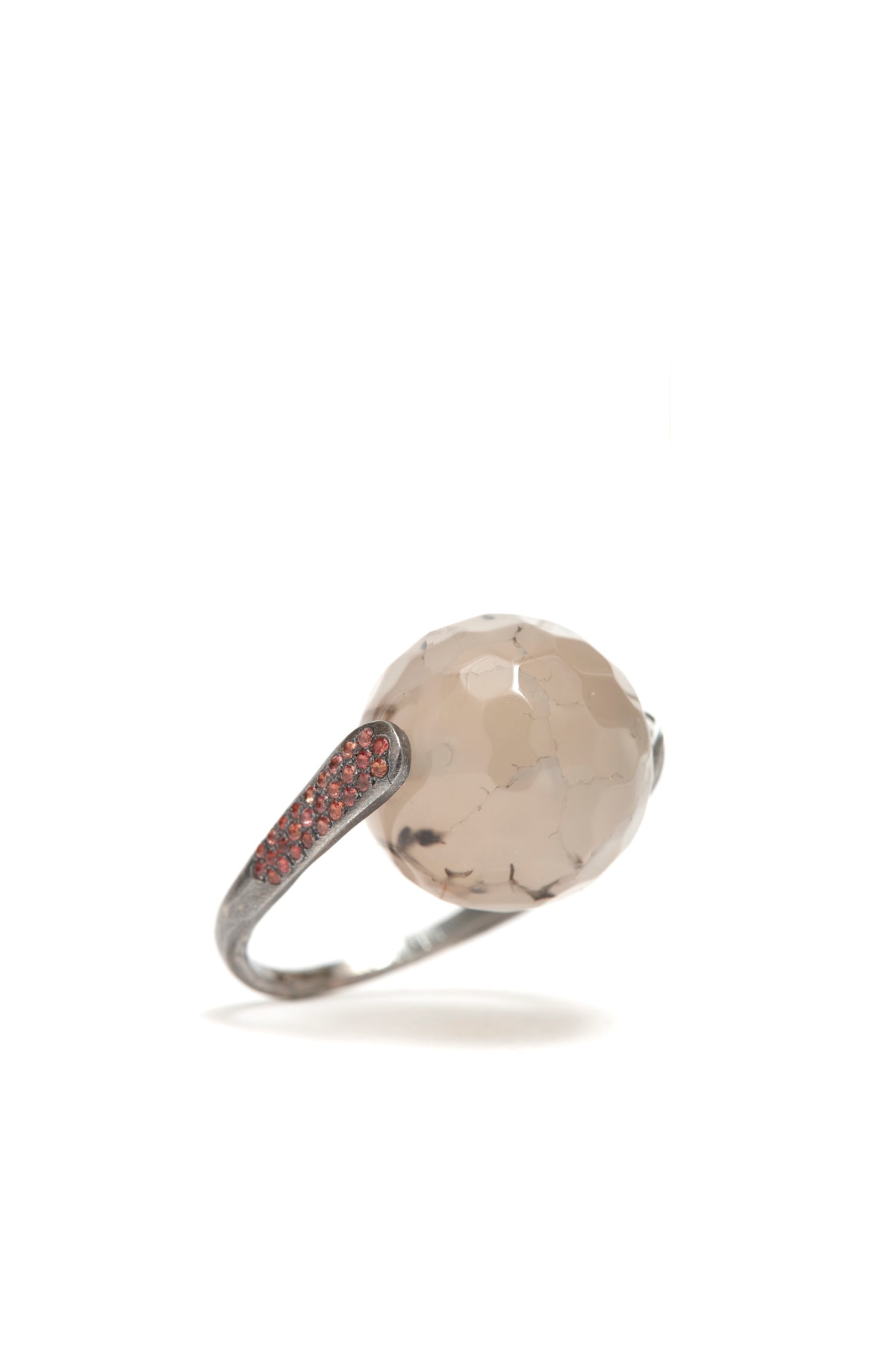Ring with a large stone and smaller stones on the band against a white background