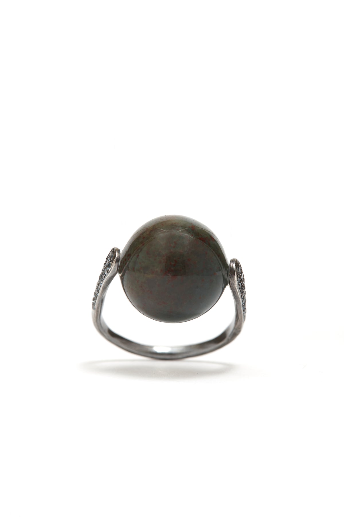 Ring with a dark stone on a white background