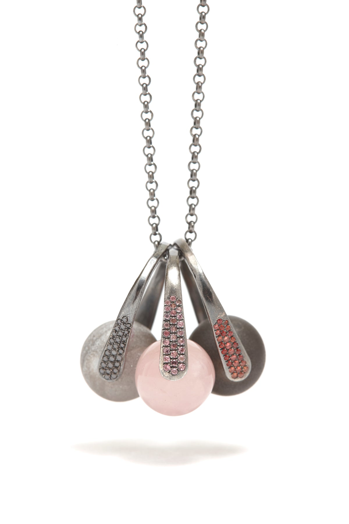 Necklace with three pendant charms on a white background