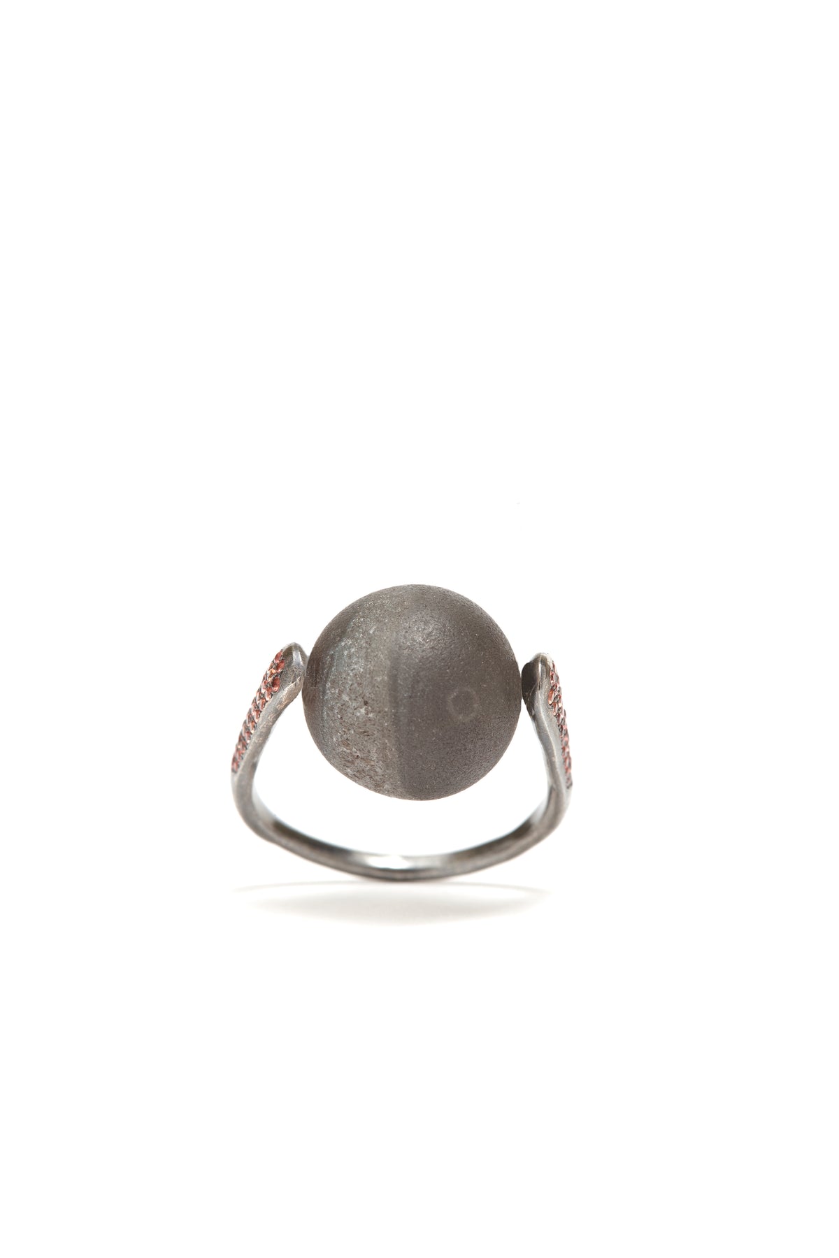 Silver ring with a large spherical stone on a white background