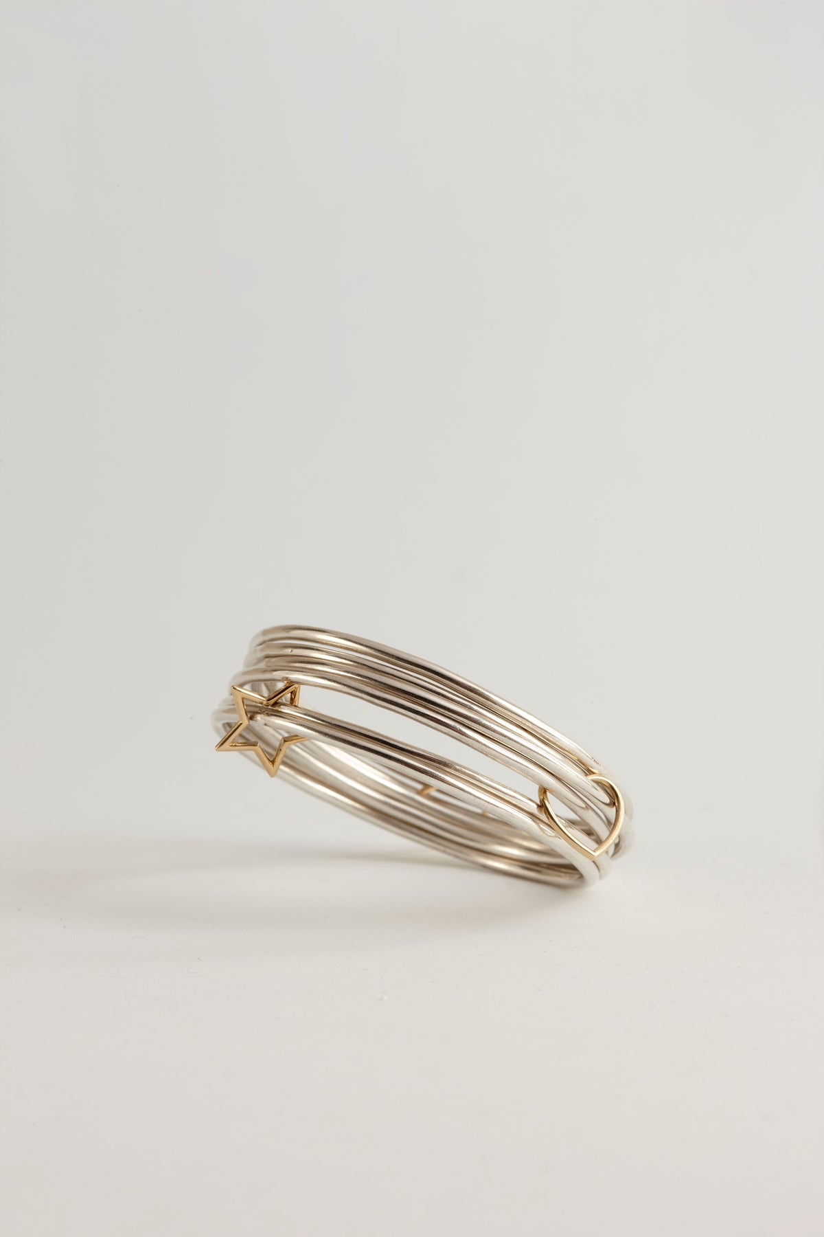 Cynthia Djurovic Together Bangles stack in sterling silver with 18k gold circle of life and star charms