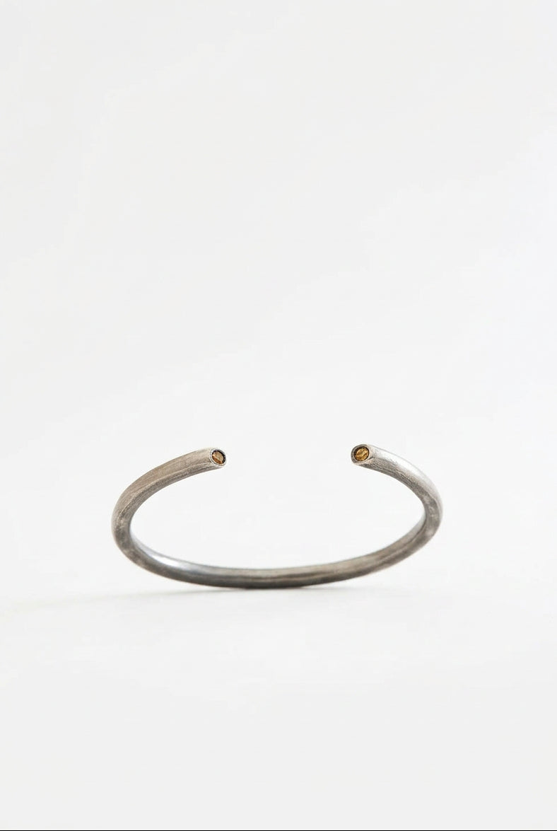 Silver bracelet on a light beige background