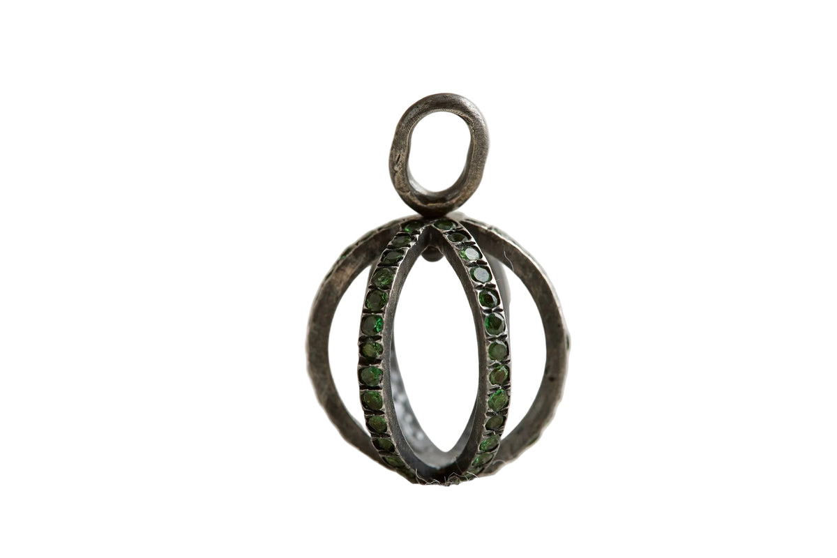 Silver ring with green gemstones on a light gray background