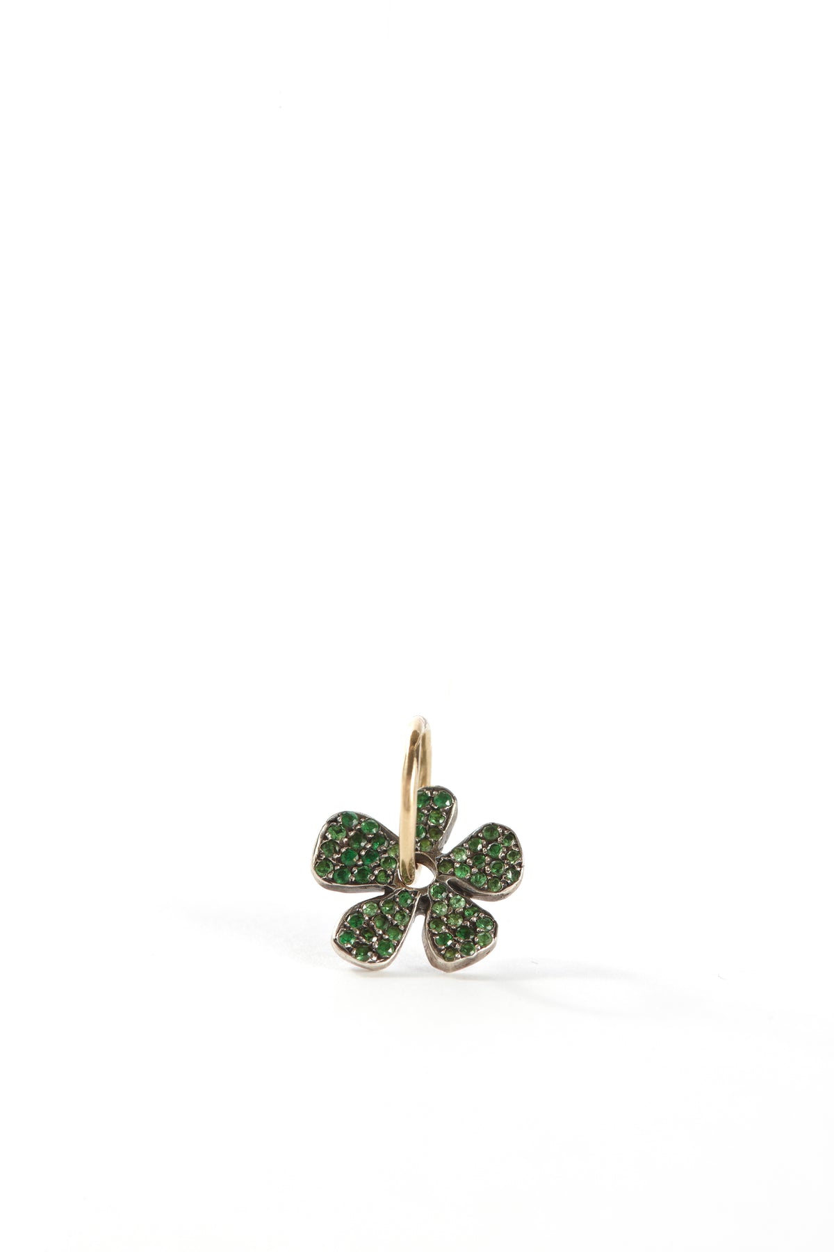 Gold four-leaf clover pendant with green gemstones on a white background