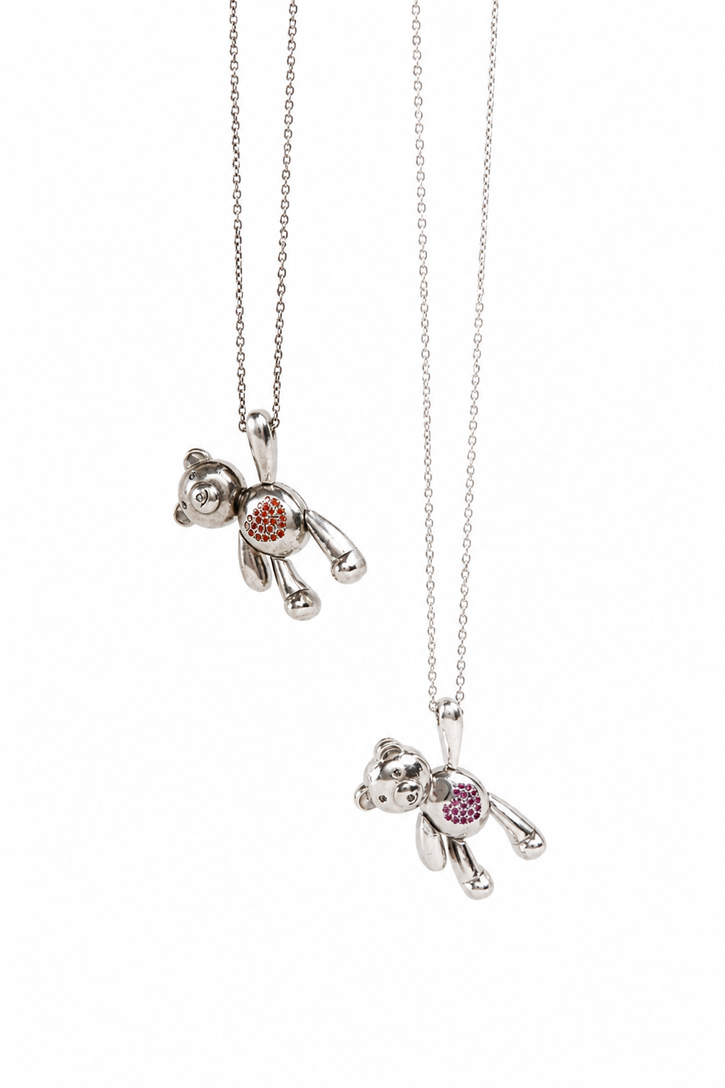 Two silver teddy bear necklaces with colorful gemstone accents on the chest, displayed against a solid white background.