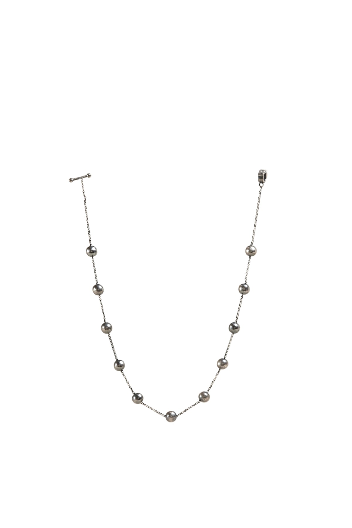 Silver necklace with beads on a white background
