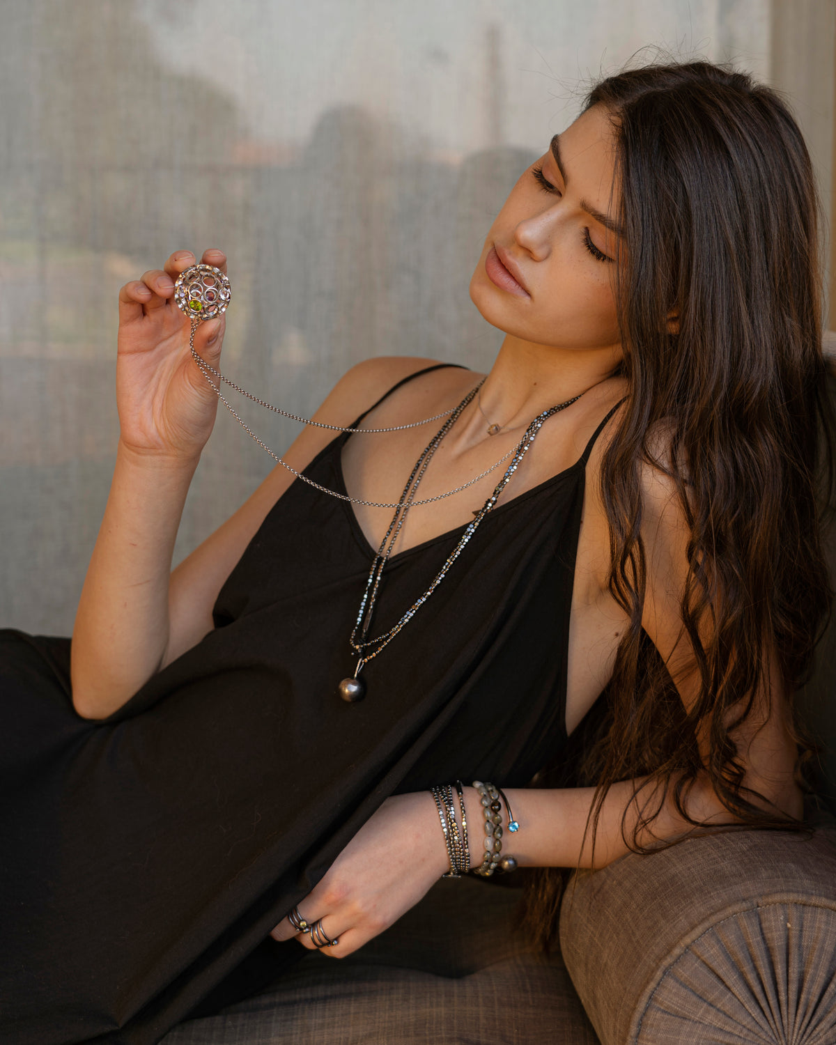 Woman holding a large diamond ring with a cityscape in the background