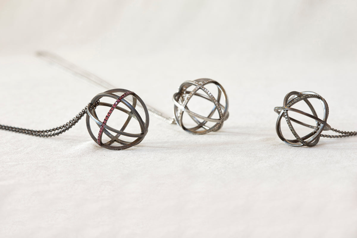 Three metallic spherical objects on a white background
