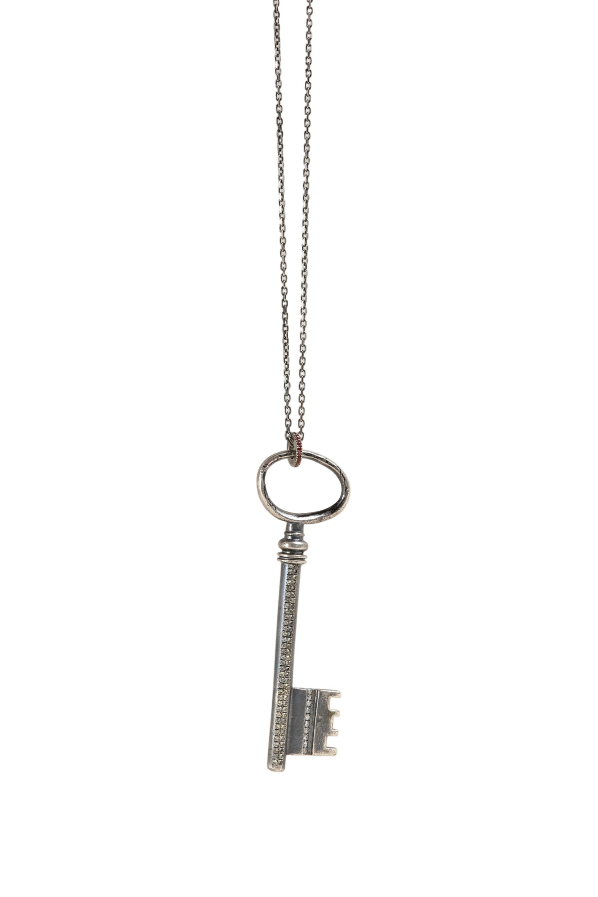 Silver key-shaped pendant on a chain against a white background