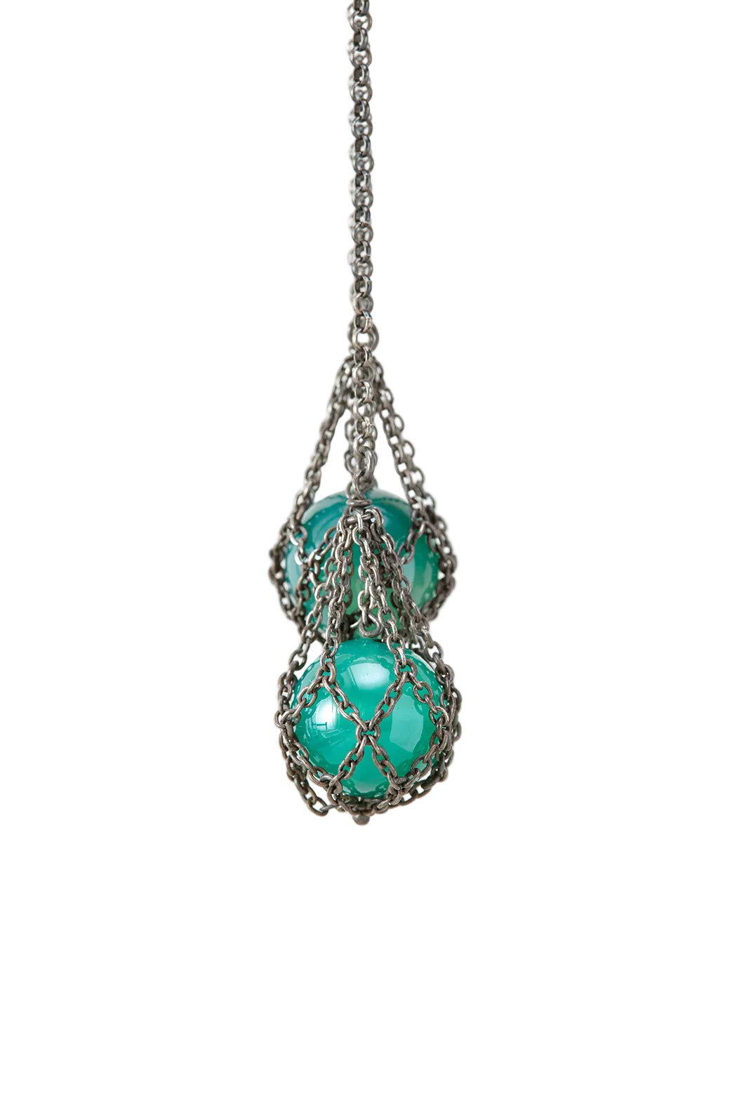 Turquoise glass beads in a metal net on a white background