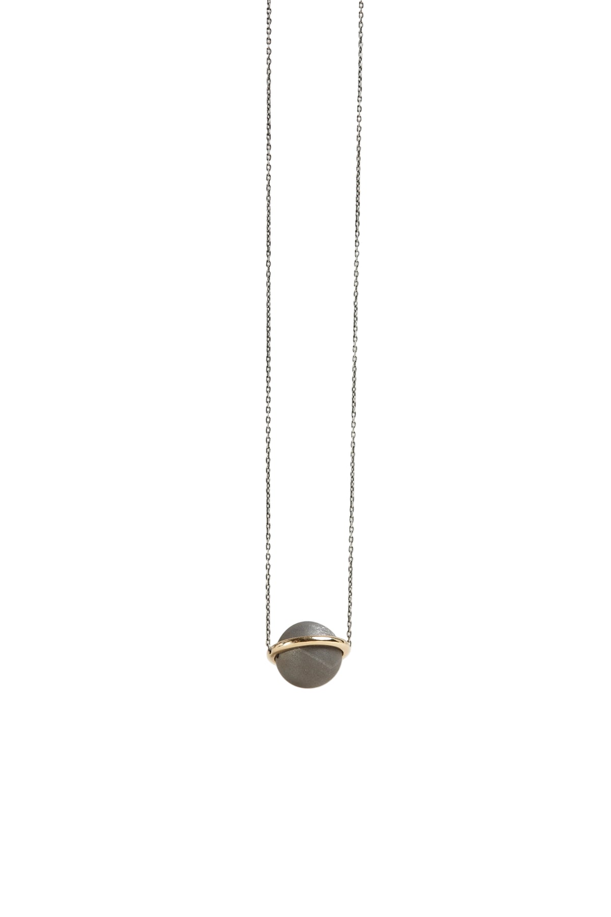Necklace with a gray pendant on a light gray background