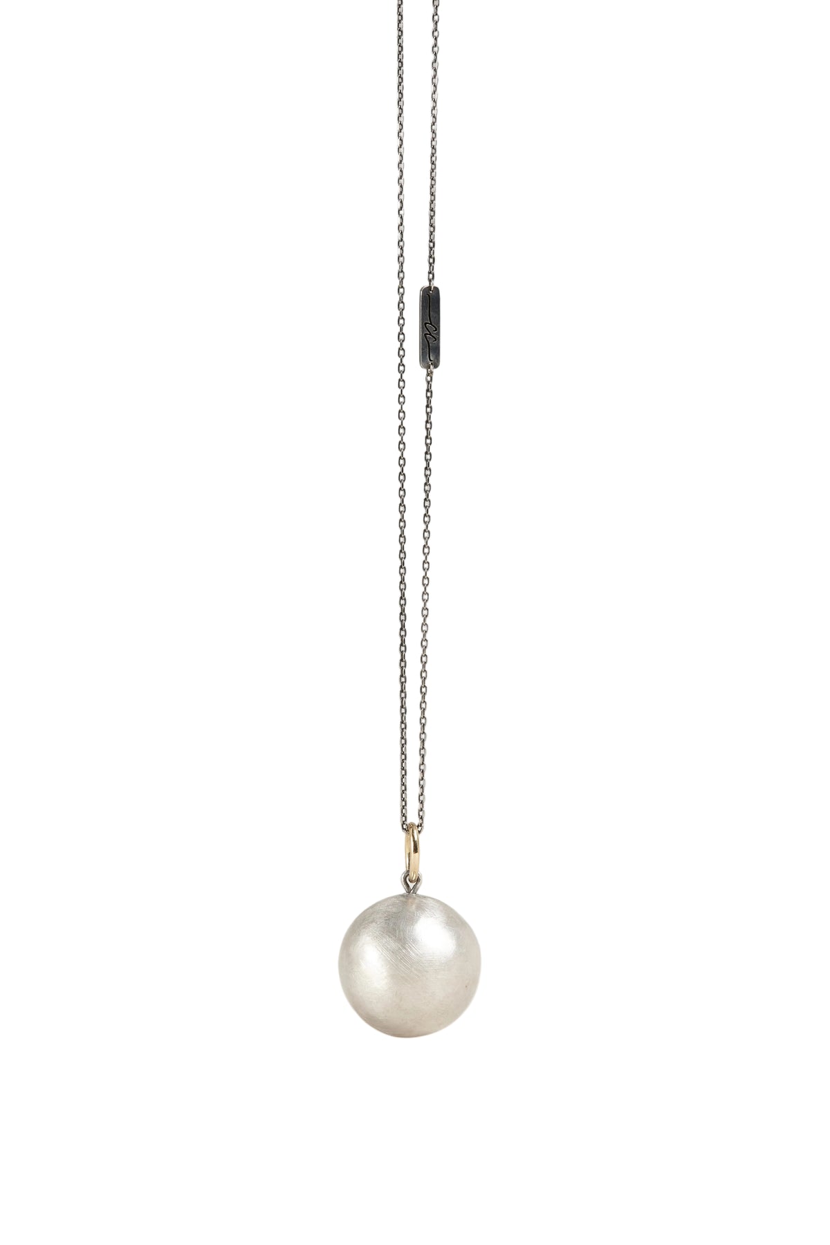 Pearl necklace with a chain on a light gray background