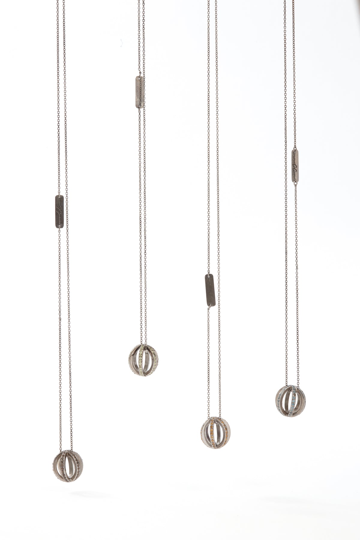 Set of four pendant lights with metallic finishes on a white background