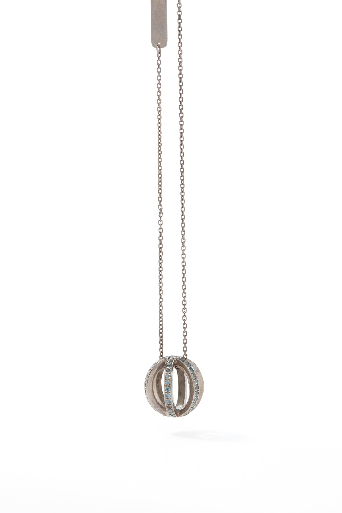 Silver necklace with a circular pendant on a white background
