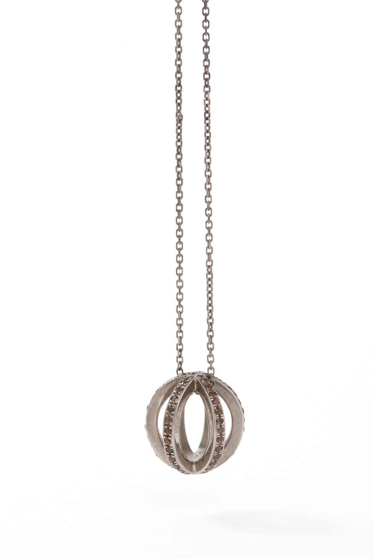 Silver necklace with a circular pendant on a white background