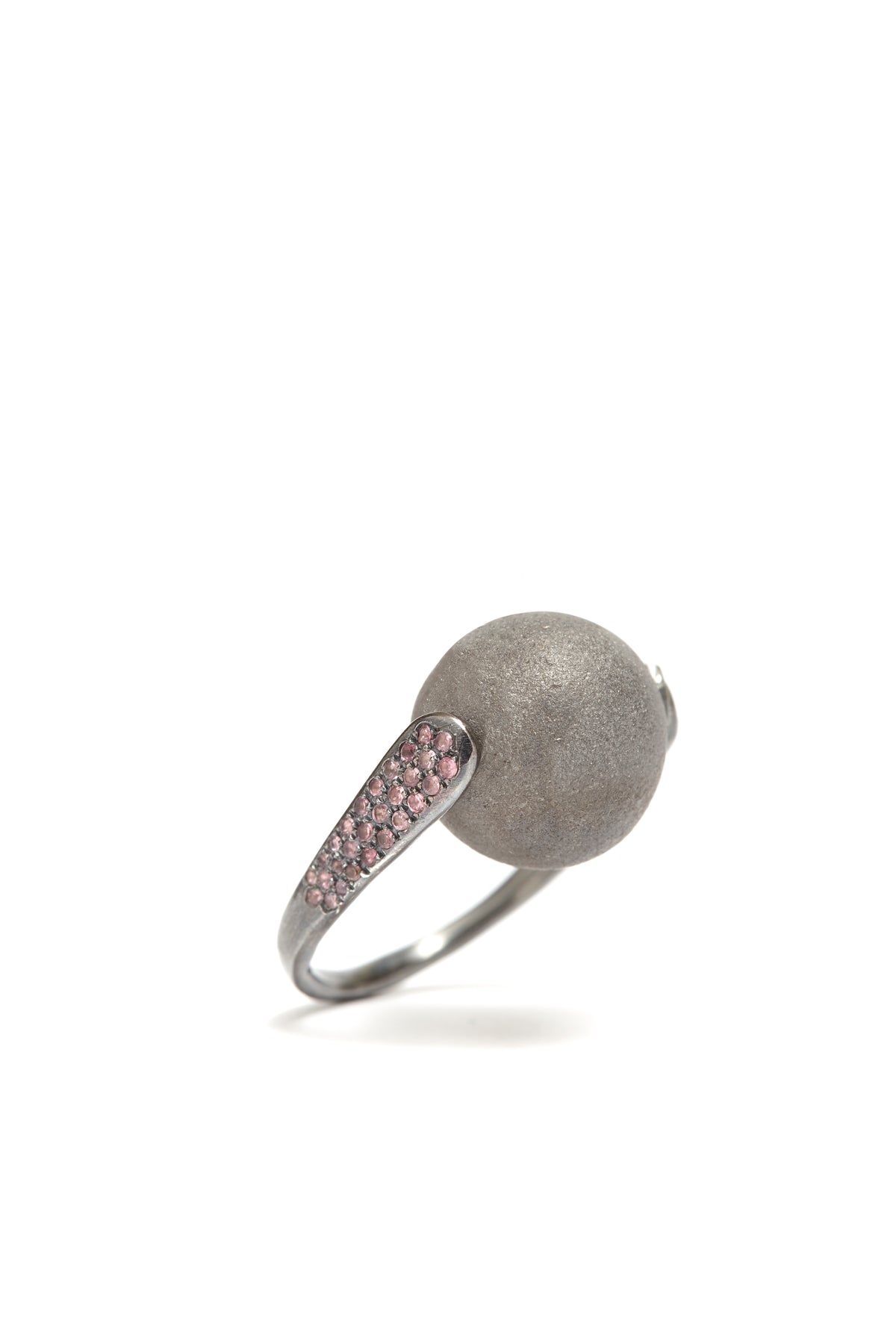 Silver ring with textured ball and pink gemstones on a white background